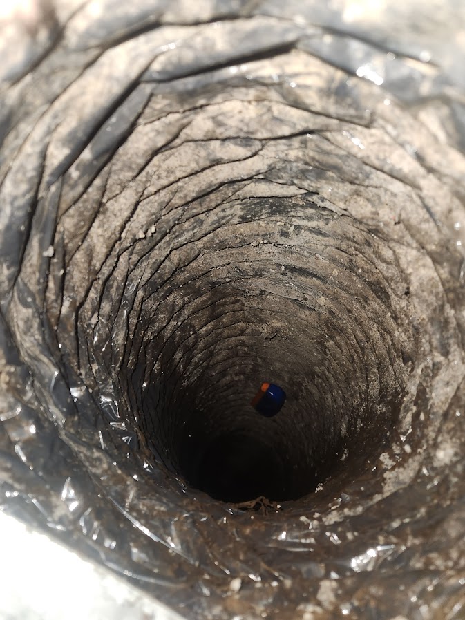 Interior view of crawl-space ductwork showing a loosened connection where moisture and musty air can enter